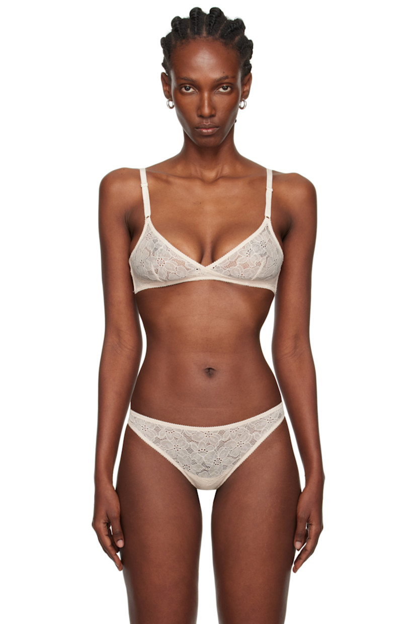 Semi-sheer stretch nylon-blend lace bra. 

· Picot trim and floral pattern throughout
· Dart at cups
· Boning at sides
· Adjustable elasticized shoulder straps
· Adjustable hook-eye fastening at back

Supplier color: Sand