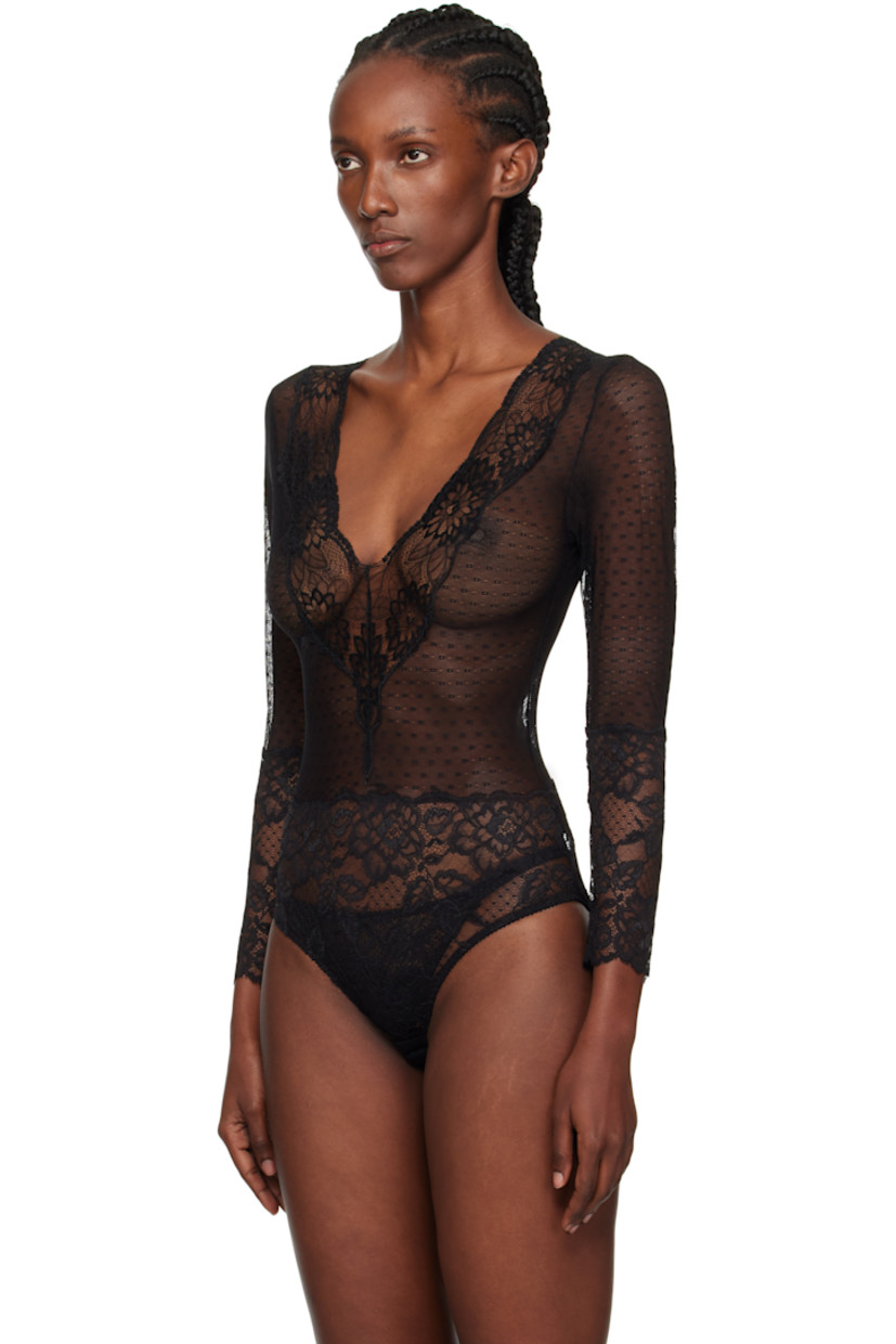 Semi-sheer stretch nylon-blend lace bodysuit.

· Floral pattern throughout
· Scalloped edge at V-neck and cuffs
· Adjustable hook-eye fastening at bottom
· Picot trim at leg openings
· Low back
· Partial jersey lining

Supplier color: Black