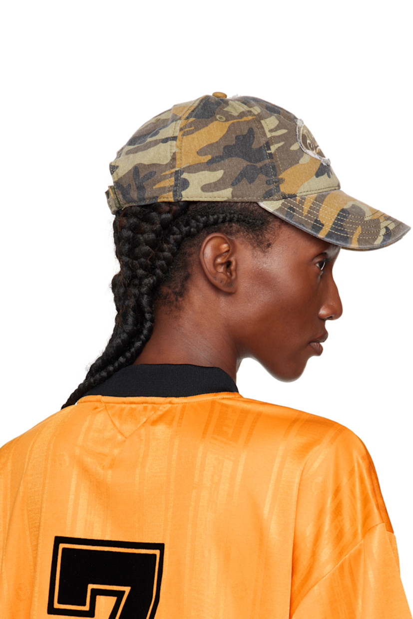 Paneled cotton twill cap.

· Camouflage pattern throughout
· Curved brim
· Embroidered logos and raw edges
· Embroidered eyelets at crown
· Velcro strap

Supplier color: Green Camo