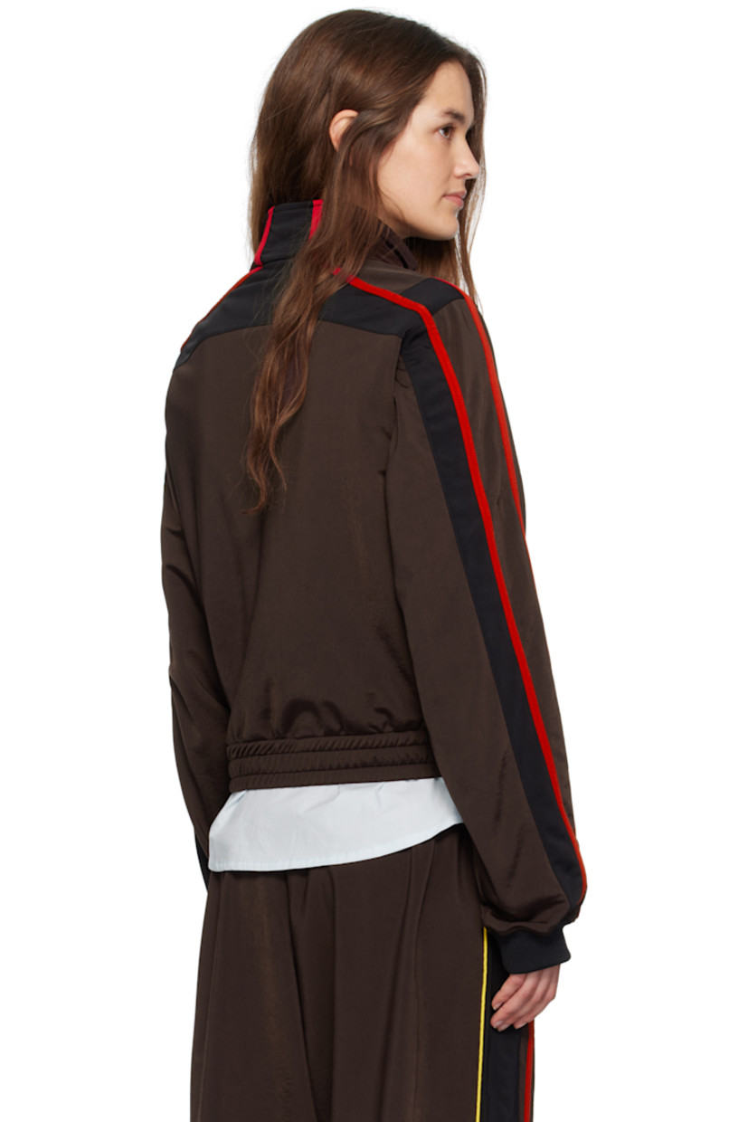 Fleece track jacket.

· Stand collar
· Two-way zip closure
· Stripe appliqués and piping at front and sleeves
· Logo embroidered at chest
· Zip pockets at front
· Elasticized hem

Supplier color: Brown/Black