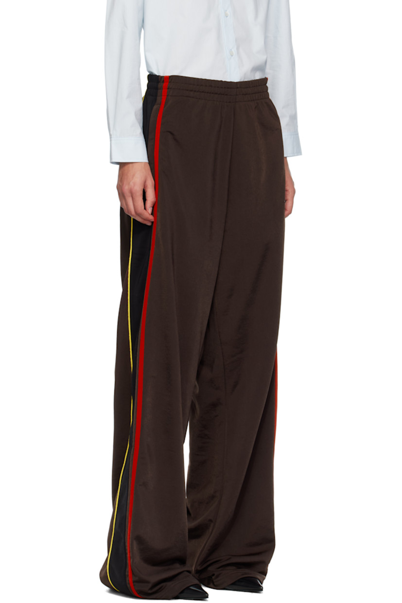 Fleece track pants.

· Concealed drawstring at elasticized waistband
· Two-pocket styling
· Logo embroidered at front
· Stripe appliqués and piping at outseams

Supplier color: Brown/Black