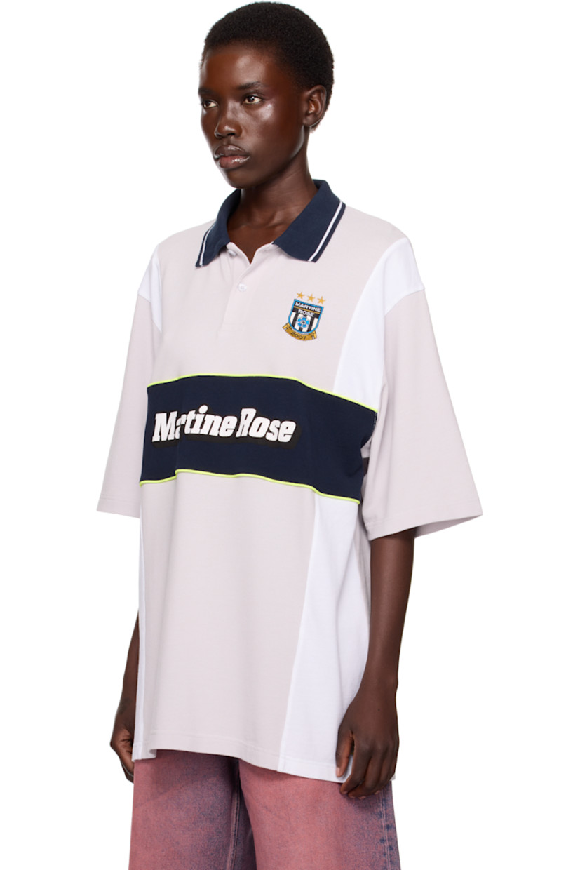 Cotton piqué polo. Stripes throughout. 

· Paneled construction 
· Striped rib-knit spread collar 
· Two-button placket 
· Logo graphic embroidered at chest
· Piping and printed logo at front 
· Vented side seams 
· Dropped shoulders

Part of the exclusive SSENSE HEAT capsule.

Supplier color: Grey navy