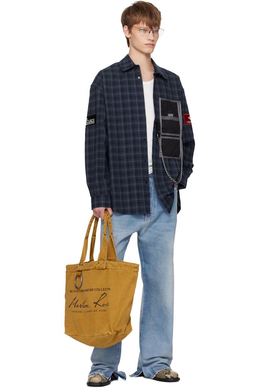 Canvas tote.

· Padded shoulder straps
· Logo-engraved O-ring and printed logo at face
· Clasp fastening at throat
· Zip pocket at interior
· H13.5" x W20" x D7"

Supplier color: Brown turmeric