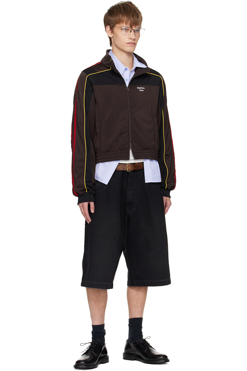 Fleece track jacket.

· Stand collar
· Two-way zip closure
· Stripe appliqués and piping at front and sleeves
· Logo embroidered at chest
· Zip pockets at front
· Elasticized hem

Supplier color: Brown/Black