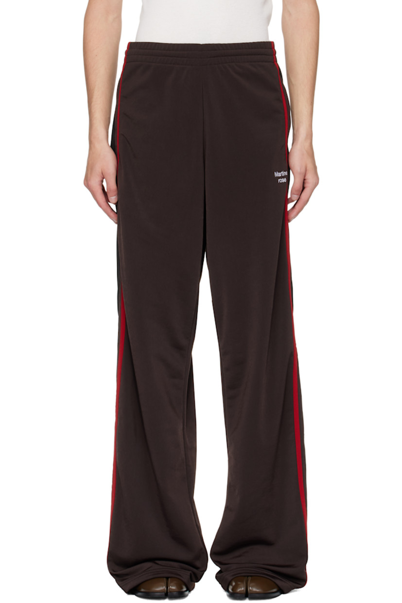 Fleece track pants.

· Concealed drawstring at elasticized waistband
· Two-pocket styling
· Logo embroidered at front
· Stripe appliqués and piping at outseams

Supplier color: Brown/Black