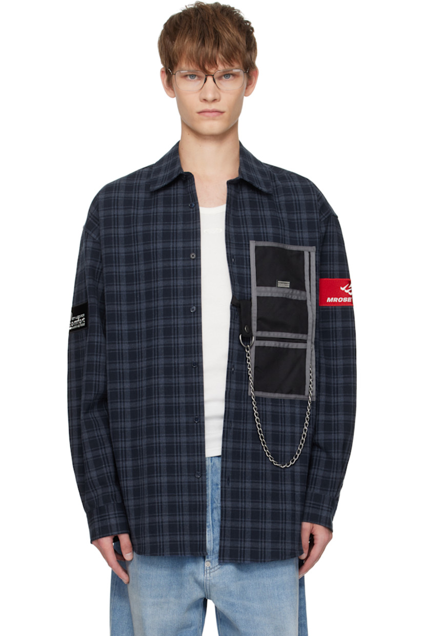 Cotton flannel shirt.

· Check pattern throughout
· Spread collar
· Button closure 
· Patch pockets and detachable curb chain at front
· Shirttail hem
· Logo patch at sleeves
· Buttoned barrel cuffs
· Logo embroidered at back

Supplier color: Blue navy check