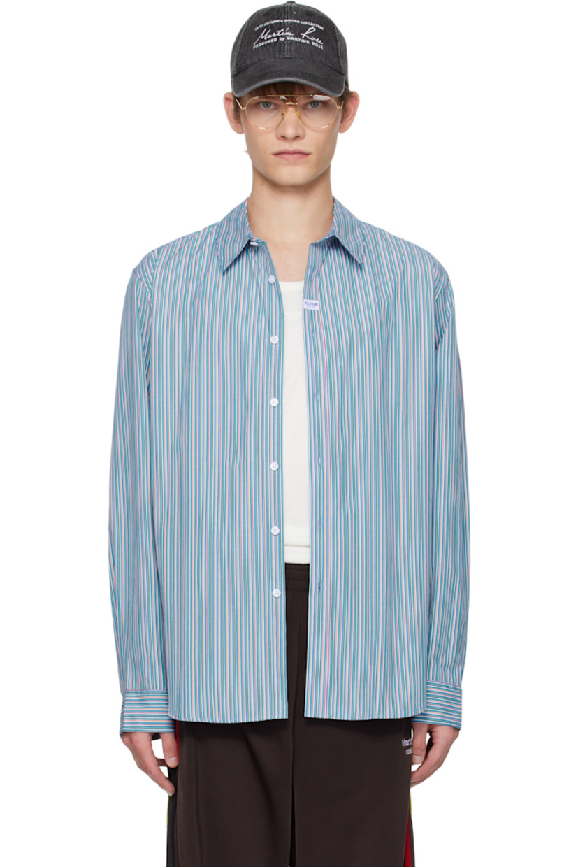 Cotton poplin shirt.

· Stripes throughout
· Spread collar
· Button closure
· Logo patch at front
· Shirttail hem
· Buttoned barrel cuffs
· Box pleat at back yoke

Supplier color: Blue/Orange stripe
