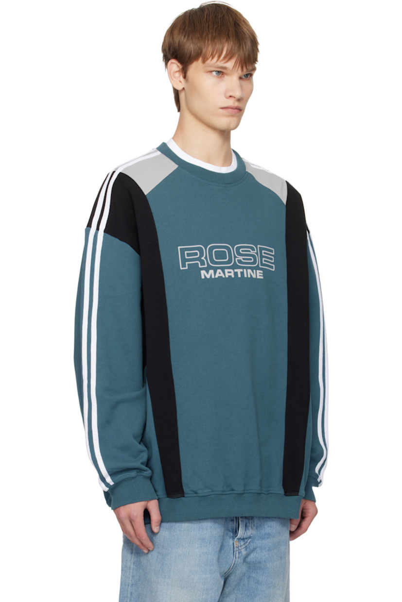 Cotton fleece sweatshirt.

· Paneled construction
· Rib-knit crewneck, hem, and cuffs
· Logo bonded at front
· Stripes at shoulders and sleeves

Supplier color: Blue Agean Rose Outline