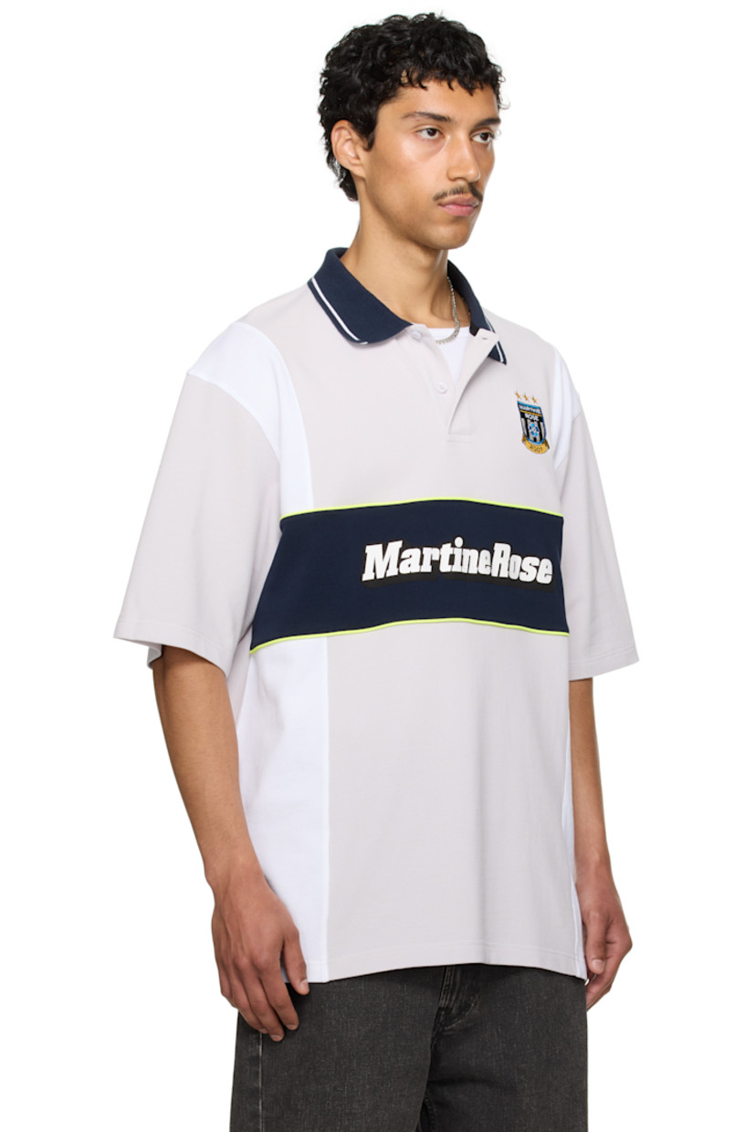 Oversized cotton piqué polo.

· Paneled construction
· Stripe at rib-knit spread collar
· Two-button placket
· Logo embroidered at chest and hem
· Piping and printed logo at front
· Tennis-tail hem
· Dropped shoulders

Part of the exclusive SSENSE HEAT capsule.

Supplier color: Grey/Navy