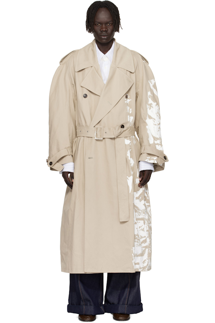 Peached cotton twill trench coat. 

· Paint splatter throughout 
· Notched lapel
· Double-breasted button closure
· Belt loops and welt pockets at waist
· Detachable pin-buckle belt 
· Epaulets at raglan sleeves
· Loops and button tab at cuffs
· Inverted box pleat at back hem 
· Full satin twill lining 

Supplier color: Medium grey