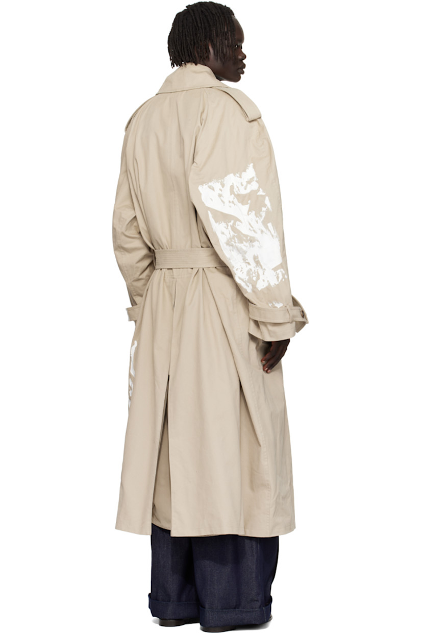 Peached cotton twill trench coat. 

· Paint splatter throughout 
· Notched lapel
· Double-breasted button closure
· Belt loops and welt pockets at waist
· Detachable pin-buckle belt 
· Epaulets at raglan sleeves
· Loops and button tab at cuffs
· Inverted box pleat at back hem 
· Full satin twill lining 

Supplier color: Medium grey