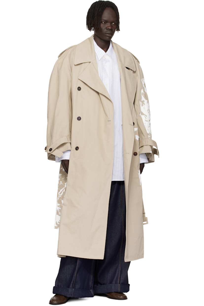 Peached cotton twill trench coat. 

· Paint splatter throughout 
· Notched lapel
· Double-breasted button closure
· Belt loops and welt pockets at waist
· Detachable pin-buckle belt 
· Epaulets at raglan sleeves
· Loops and button tab at cuffs
· Inverted box pleat at back hem 
· Full satin twill lining 

Supplier color: Medium grey