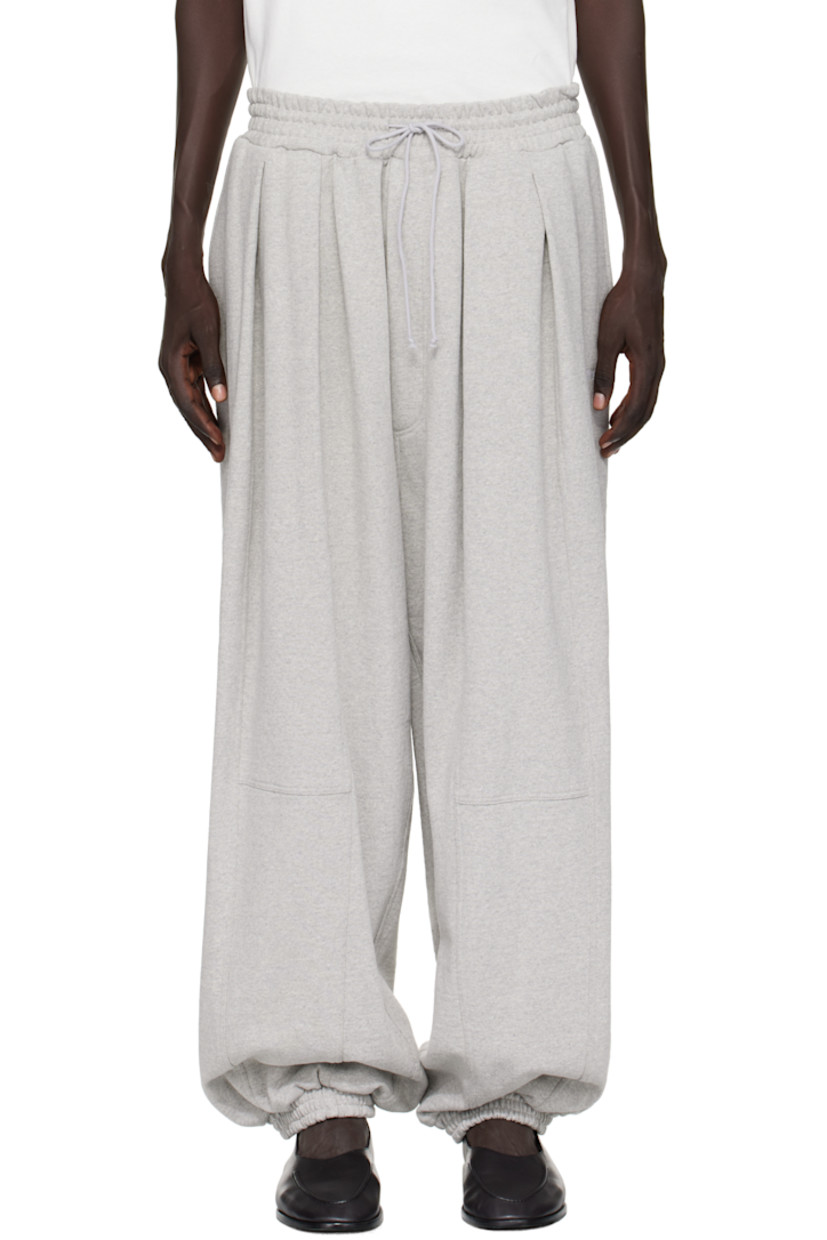 Heavyweight recycled cotton-blend French terry sweatpants.

· Drawstring at elasticized waistband
· Two-pocket styling
· Mock fly 
· Pleats at front 
· Logo embroidered at leg 
· Elasticized cuffs

Supplier color: Medium grey