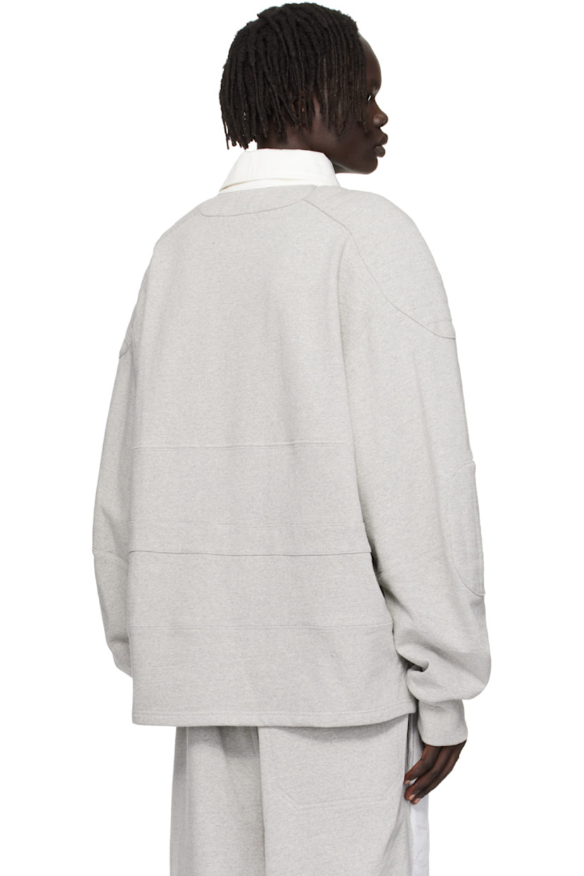 Recycled cotton-blend French terry polo. 

· Paneled construction
· Cotton twill spread collar  
· Concealed four-button placket  
· Vented side seams 
· Quilted panel at modified saddle shoulders
· Quilted elbow patches
· Rib-knit cuffs

Supplier color: Medium grey