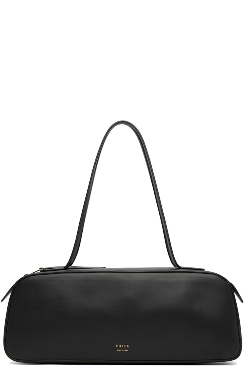 Buffed calfskin shoulder bag.

· Fixed shoulder straps
· Gold-tone logo stamp at face
· Zip closure
· Suede interior
· Logo-engraved gold-tone hardware
· H5" x W13.5" x D3"

Supplier color: Black