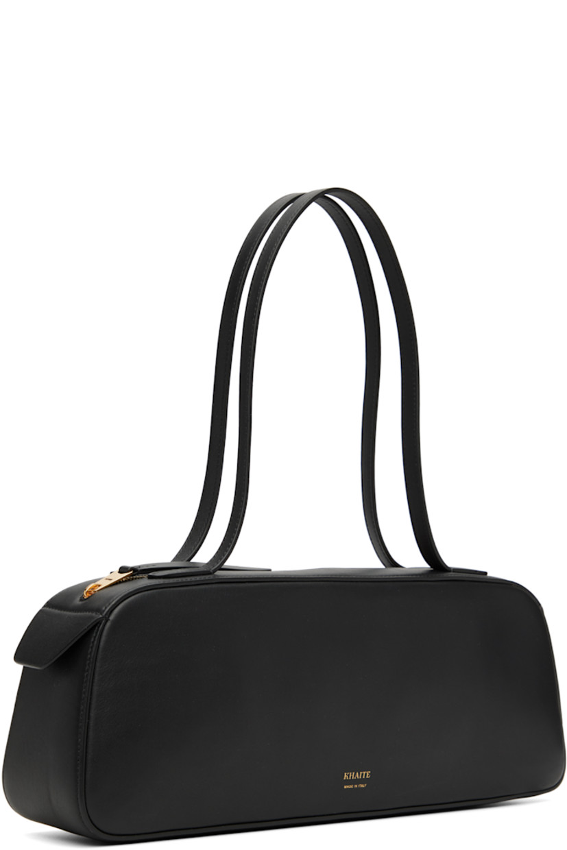 Buffed calfskin shoulder bag.

· Fixed shoulder straps
· Gold-tone logo stamp at face
· Zip closure
· Suede interior
· Logo-engraved gold-tone hardware
· H5" x W13.5" x D3"

Supplier color: Black
