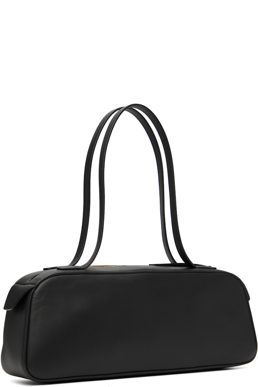 Buffed calfskin shoulder bag.

· Fixed shoulder straps
· Gold-tone logo stamp at face
· Zip closure
· Suede interior
· Logo-engraved gold-tone hardware
· H5" x W13.5" x D3"

Supplier color: Black