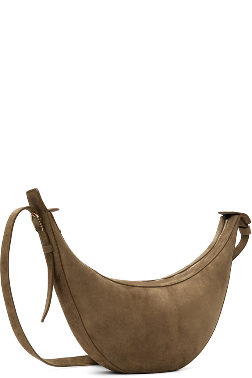 Calfskin suede shoulder bag.

· Adjustable crossbody strap
· Embossed logo at face
· Zip closure
· Grained calfskin interior
· Unlined
· H7" x W15" x D2.75"

Supplier color: Mud suede