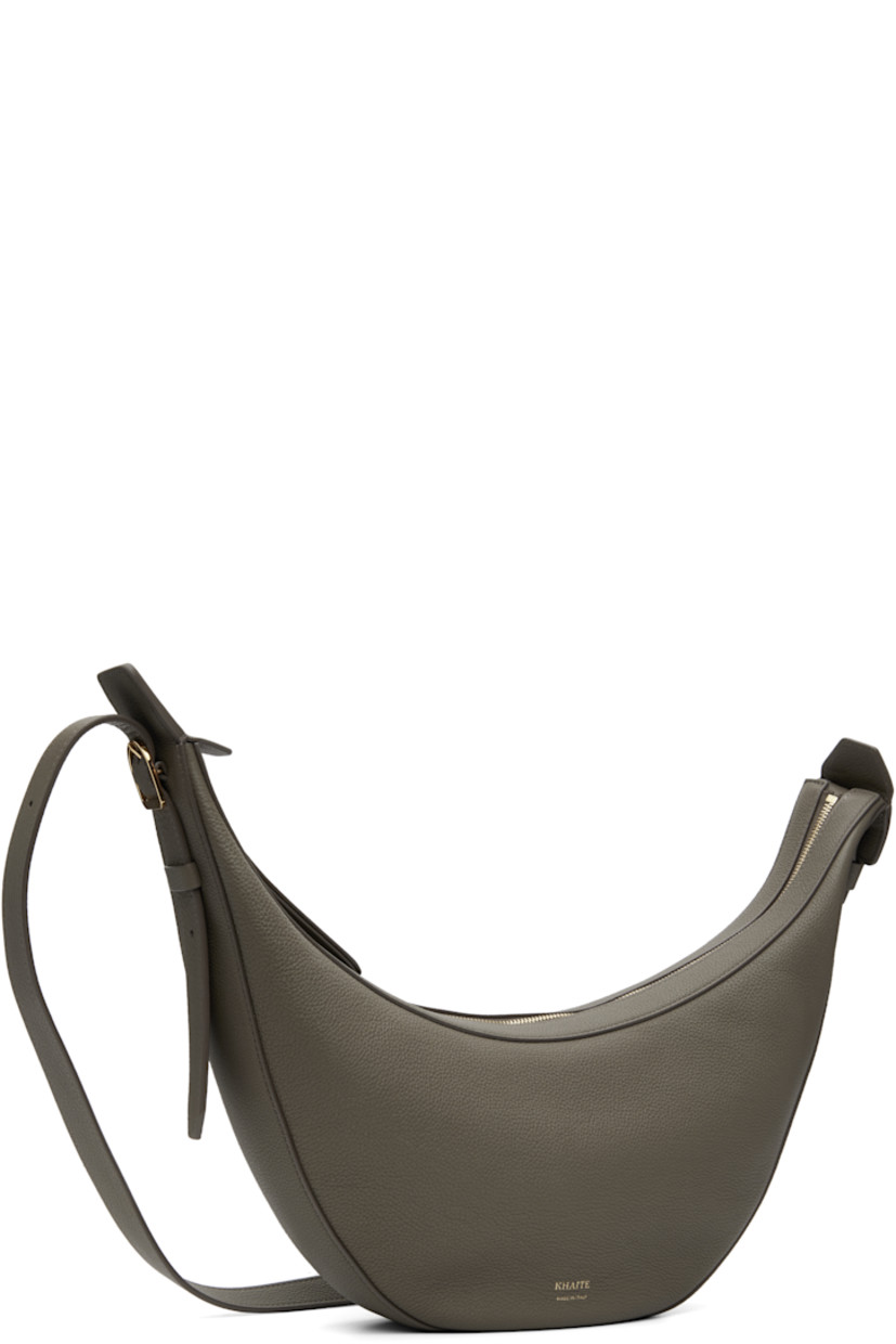 Pebble-grained calfskin shoulder bag.

· Adjustable crossbody strap
· Logo stamp at face
· Zip closure
· Suede interior
· Unlined
· H7" x W15" x D2.75"

Supplier color: Elephant
