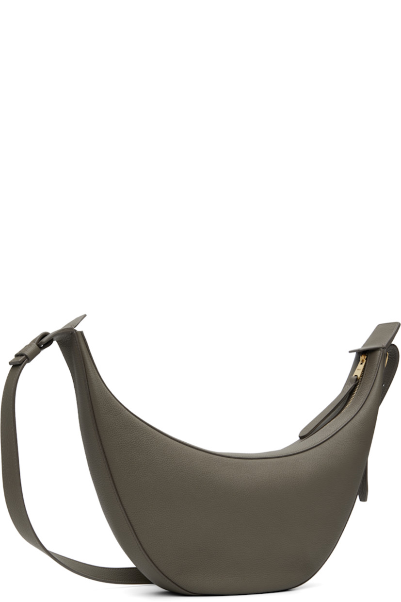 Pebble-grained calfskin shoulder bag.

· Adjustable crossbody strap
· Logo stamp at face
· Zip closure
· Suede interior
· Unlined
· H7" x W15" x D2.75"

Supplier color: Elephant