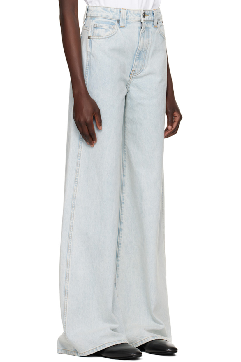 Flared wide-leg stretch denim jeans. Fading, whiskering, and subtle distressing throughout.

· High-rise
· Belt loops
· Five-pocket styling
· Button fly
· Logo-engraved gunmetal-tone hardware
· Contrast stitching in tan

Supplier color: Shelburne