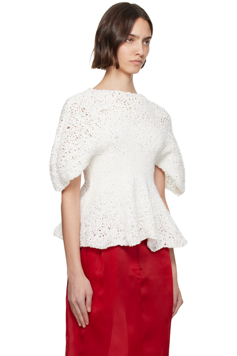 Semi-sheer hand-knit cotton-blend top. 

· Boatneck
· Peplum hem
· Yoke sleeves

Supplier color: Glaze