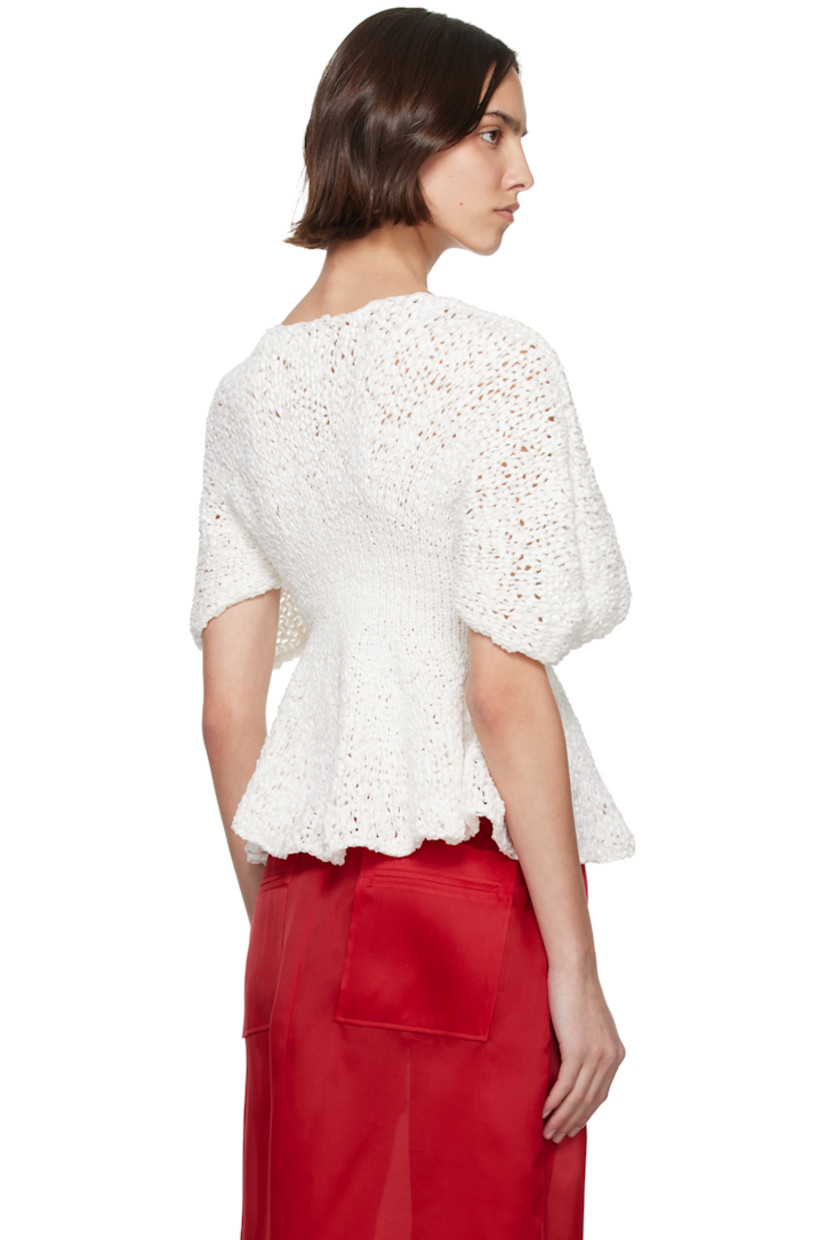 Semi-sheer hand-knit cotton-blend top. 

· Boatneck
· Peplum hem
· Yoke sleeves

Supplier color: Glaze