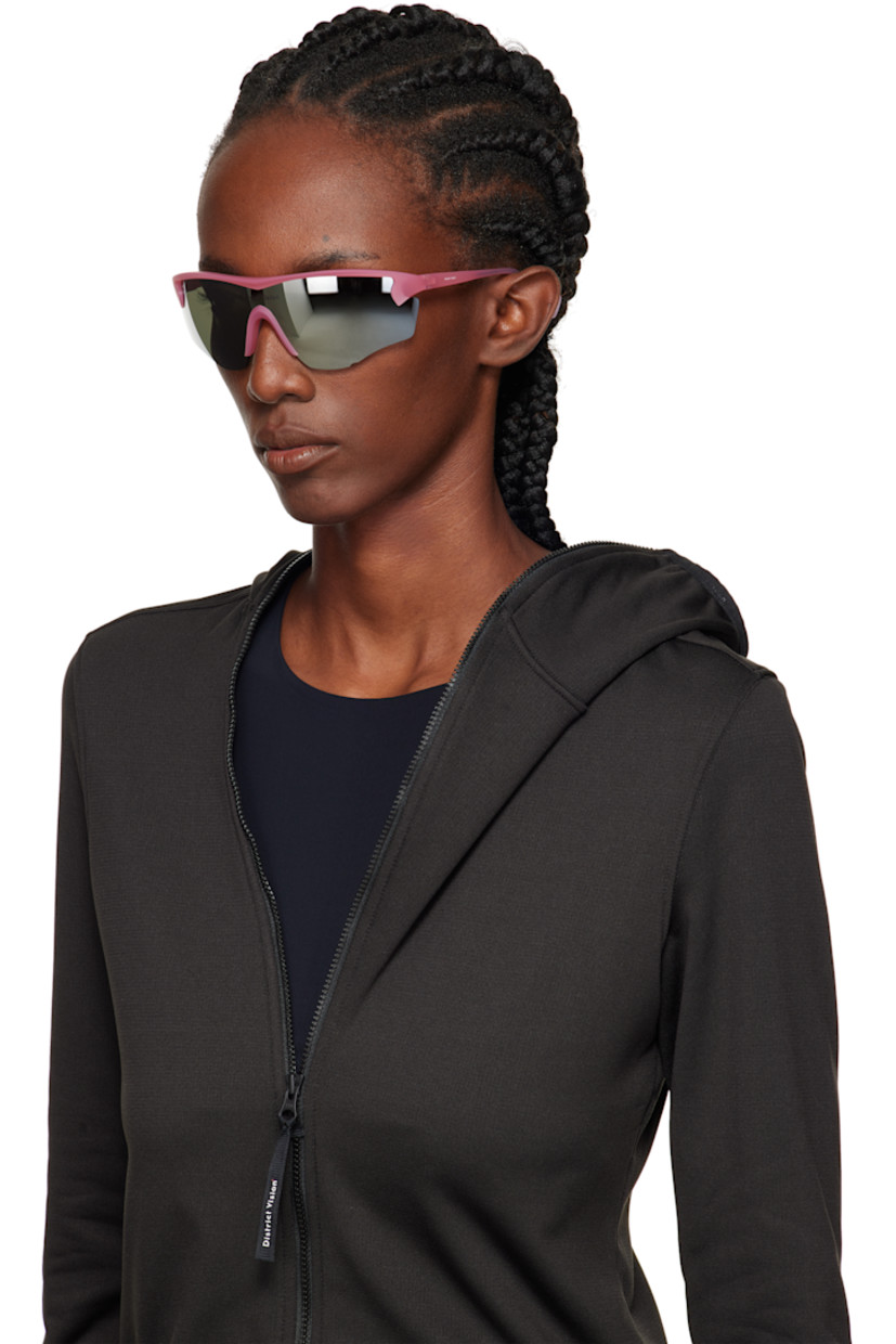 Shield-style semi-rimless semi-transparent acrylic-frame sunglasses.

· Mirrored silver tone lens with D+ lens technology
· 100% UVA/UVB protection
· Integrated rubber nose pads
· Logo printed at lens and temple
· Core wires
· Eyewear chain-compatible rubber temple tips
· Includes microfiber pouch
· Size: 140 125

Supplier color: Powder rose/D+ silver flash mirror