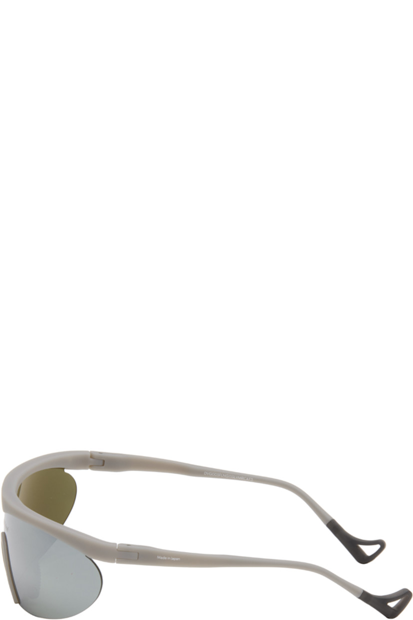 Shield-style semi-rimless acrylic-frame sunglasses.

· Mirrored silver tone lens with D+ lens technology
· 100% UVA/UVB protection
· Integrated rubber nose pads
· Logo printed at lens and temple
· Eyewear chain-compatible rubber temple tips
· Titanium hardware
· Includes microfiber pouch
· Size: 136 125

Supplier color: Flint/D+ G15  silver flash mirror