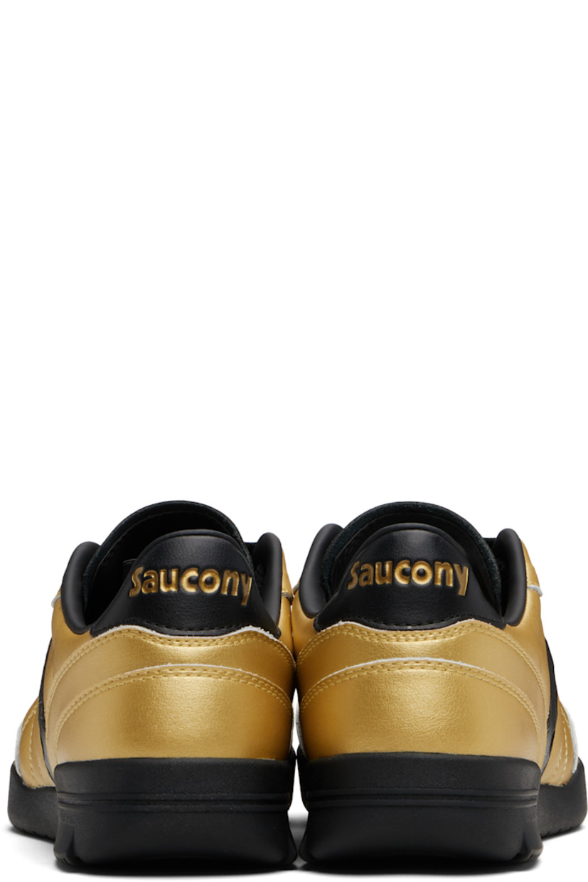 Low-top quilted grained leather sneakers.

· Lace-up closure
· Logo embossed at tongue
· Padded collar
· Logo appliqué at sides
· Logo embossed at heel tab
· Mesh lining
· Treaded rubber sole

Supplier color: Rich gold