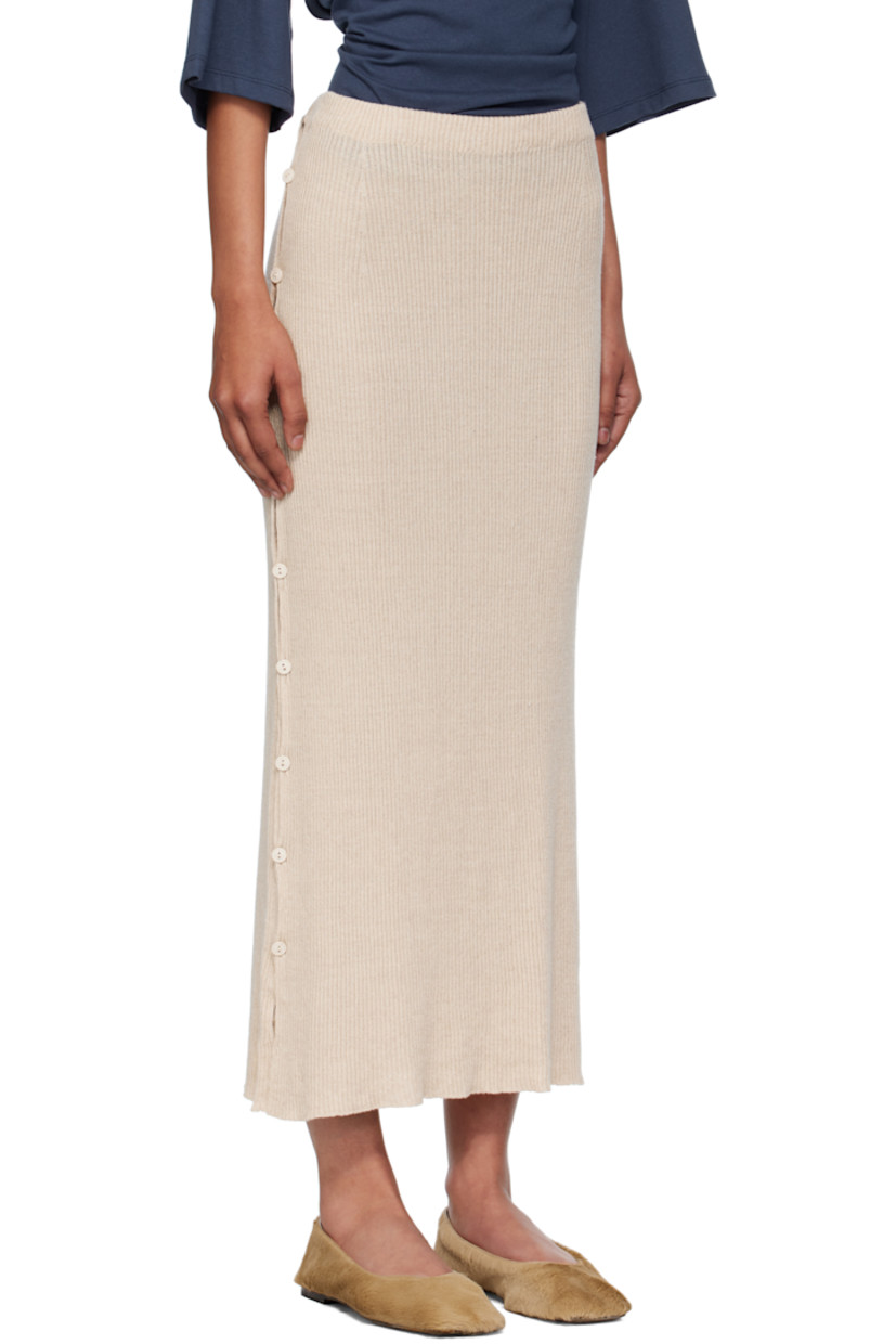 Rib-knit linen- and organic cotton-blend midi skirt. 

· OEKO-TEX®-certified cotton 
· Elasticized waistband
· Buttoned vent at side seams 

Supplier color: Lata beige