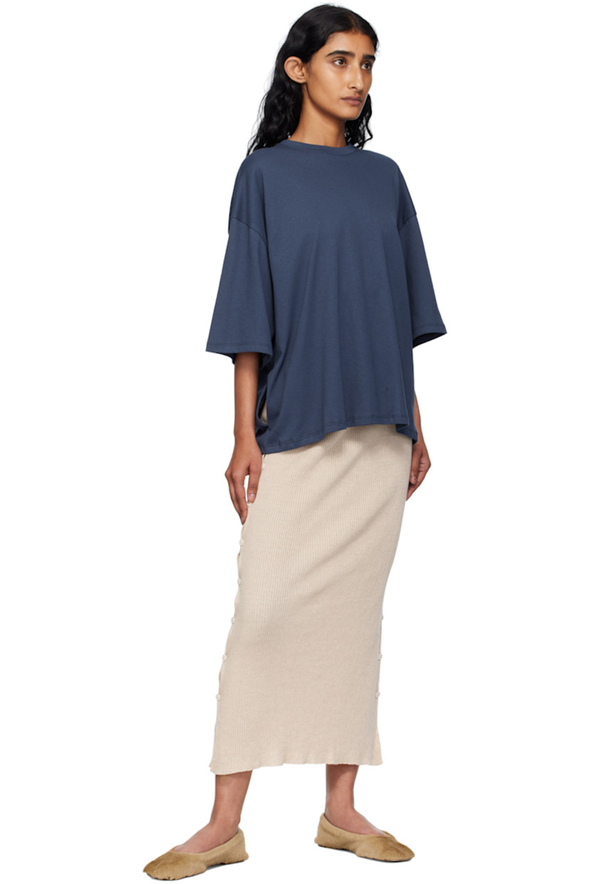 Rib-knit linen- and organic cotton-blend midi skirt. 

· OEKO-TEX®-certified cotton 
· Elasticized waistband
· Buttoned vent at side seams 

Supplier color: Lata beige