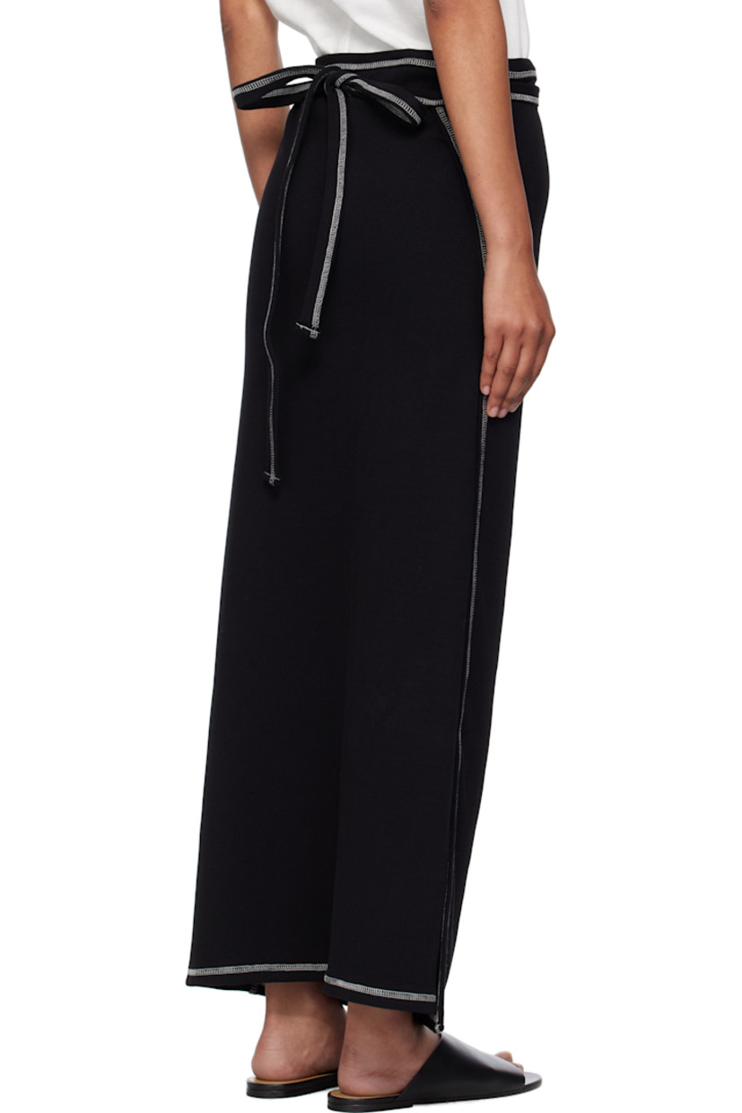Stretch organic cotton- and recycled cotton-blend ribbed jersey maxi skirt.

· Wrap construction 
· Elasticized waistband
· Self-tie straps at waistband
· Contrast overlock stitching in white 

Supplier color: Black