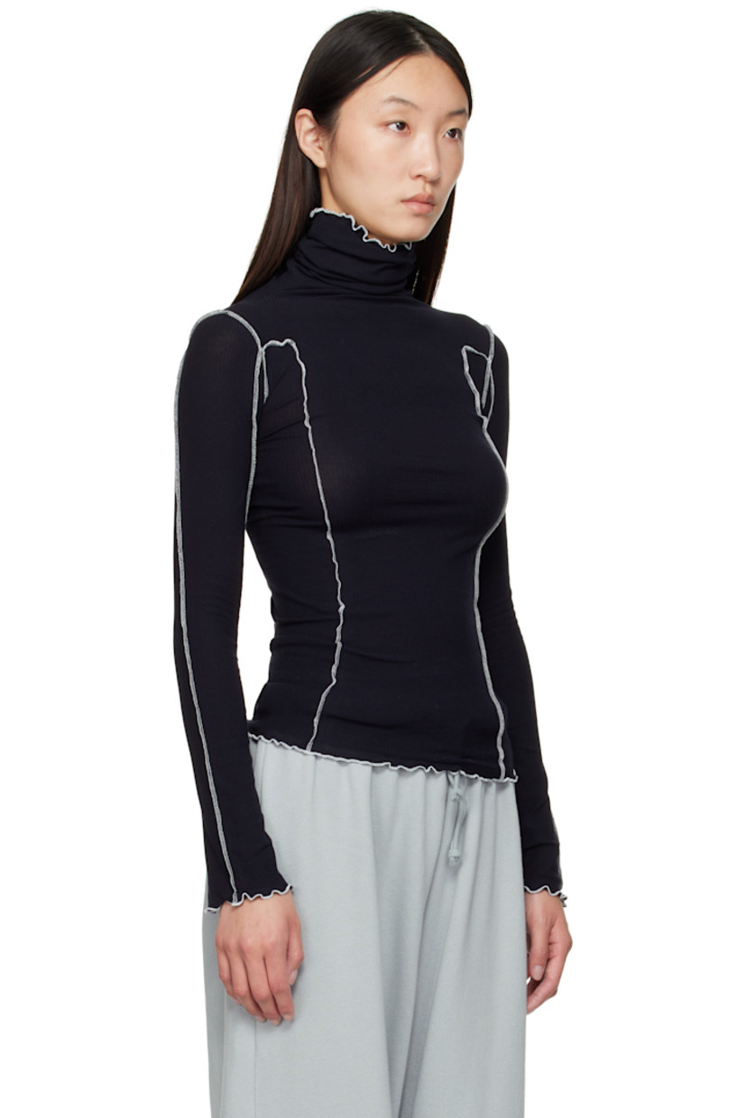 Ribbed stretch organic cotton jersey turtleneck. 

· GOTS-, OEKO-TEX®-, and OCS 100-certified
· Exposed seams throughout
· Lettuce edge at collar, hem, and cuffs
· Contrast stitching in white 

Supplier color: Murano navy/Undyed