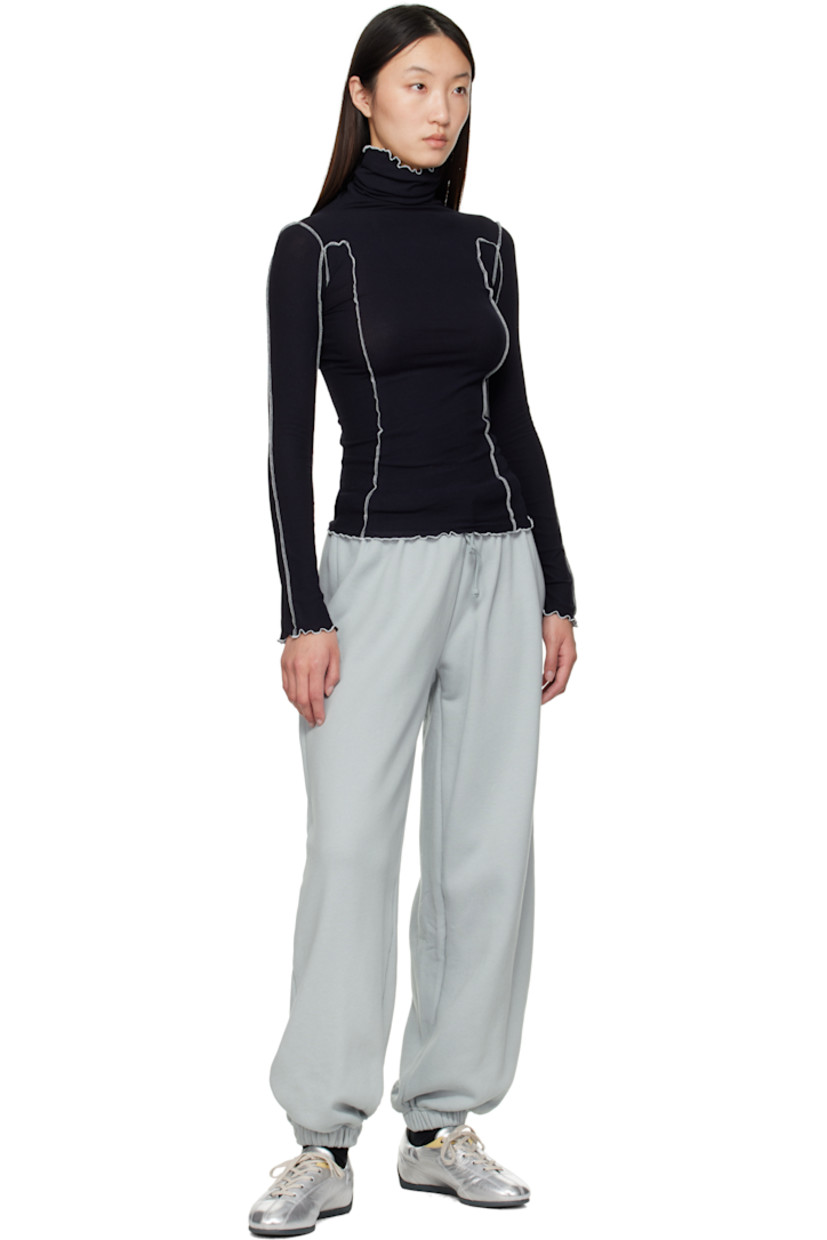 Ribbed stretch organic cotton jersey turtleneck. 

· GOTS-, OEKO-TEX®-, and OCS 100-certified
· Exposed seams throughout
· Lettuce edge at collar, hem, and cuffs
· Contrast stitching in white 

Supplier color: Murano navy/Undyed