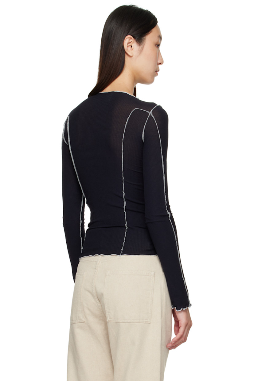 Ribbed stretch organic cotton jersey T-shirt. 

· GOTS-, OEKO-TEX®-, and OCS 100-certified
· Exposed seams throughout
· Lettuce edge at boatneck, hem, and cuffs
· Contrast stitching in white 

Supplier color: Murano navy/Undyed