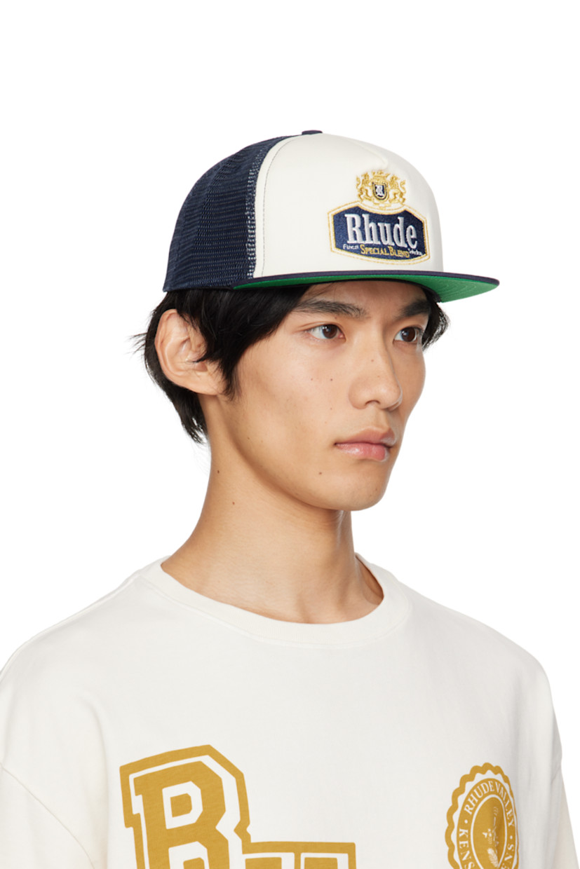 Paneled twill and mesh cap. 

· Embroidered eyelets at crown 
· Embroidered graphic and logo at face
· Flat brim 
· Snapback fastening at back
· Twill browband and lining 

Supplier color: Navy/Off-white