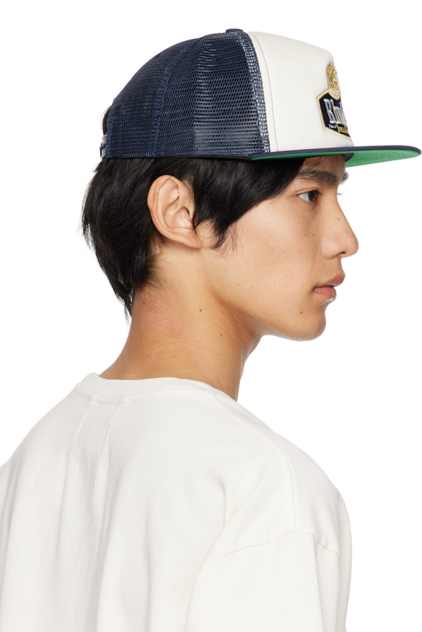 Paneled twill and mesh cap. 

· Embroidered eyelets at crown 
· Embroidered graphic and logo at face
· Flat brim 
· Snapback fastening at back
· Twill browband and lining 

Supplier color: Navy/Off-white