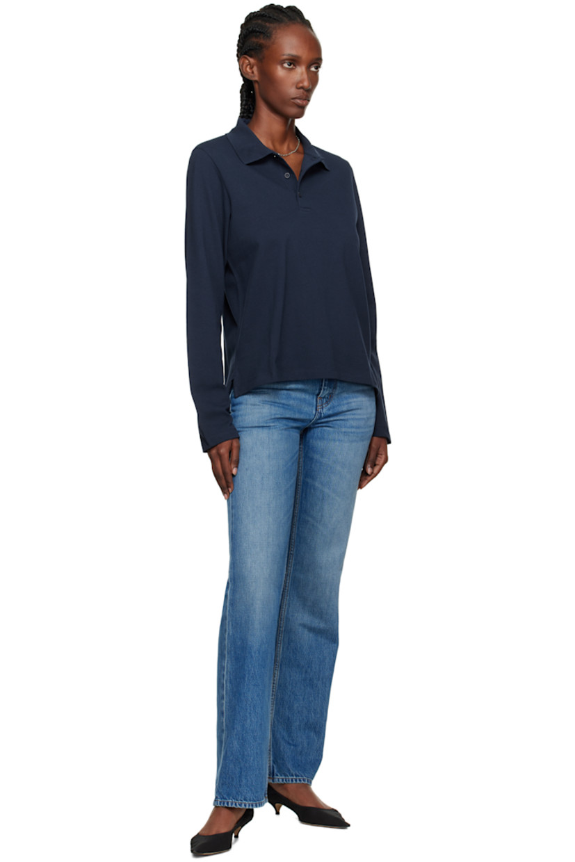 Organic cotton jersey polo.

· Rib-knit spread collar
· Three-button placket
· Vents at hem
· Mother-of-pearl hardware

Supplier color: Navy