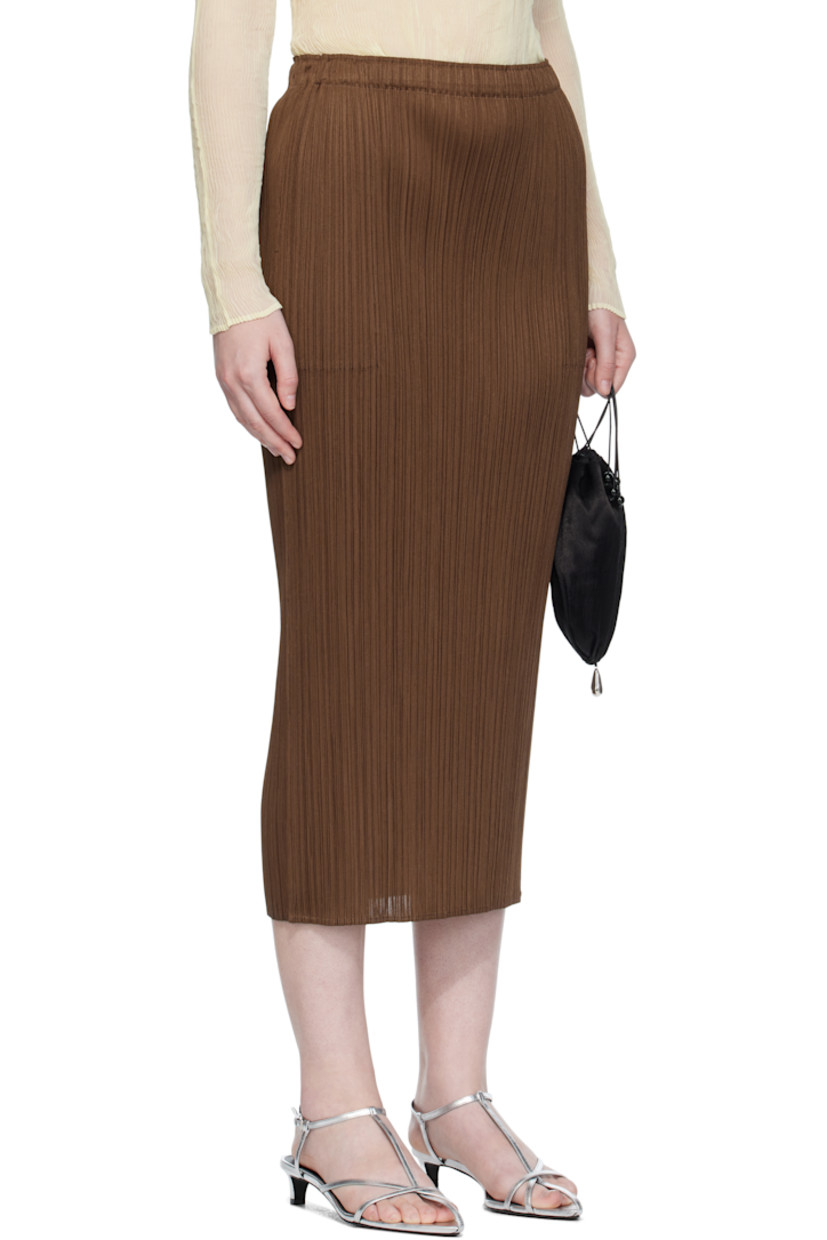 Garment-pleated tricot midi skirt.

· Elasticized waistband
· Two-pocket styling

Supplier color: Brown
