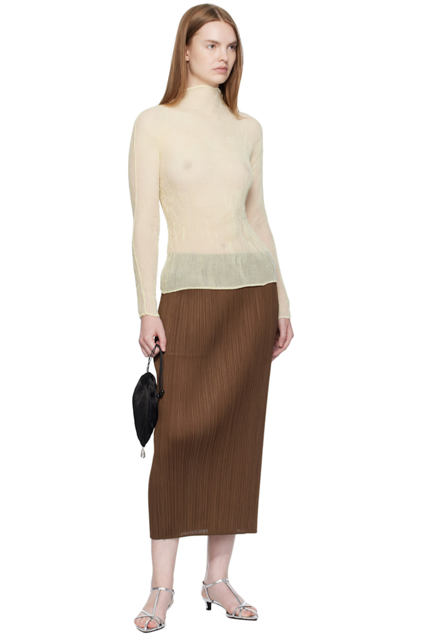 Garment-pleated tricot midi skirt.

· Elasticized waistband
· Two-pocket styling

Supplier color: Brown