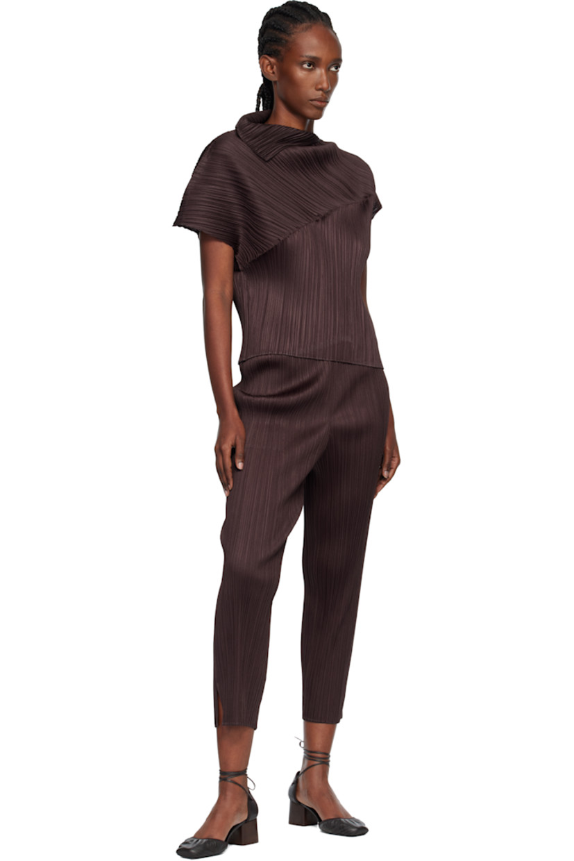 Garment-pleated tricot top.

· Foldover neck
· Asymmetrical hem and cap sleeves

Supplier color: Dark brown