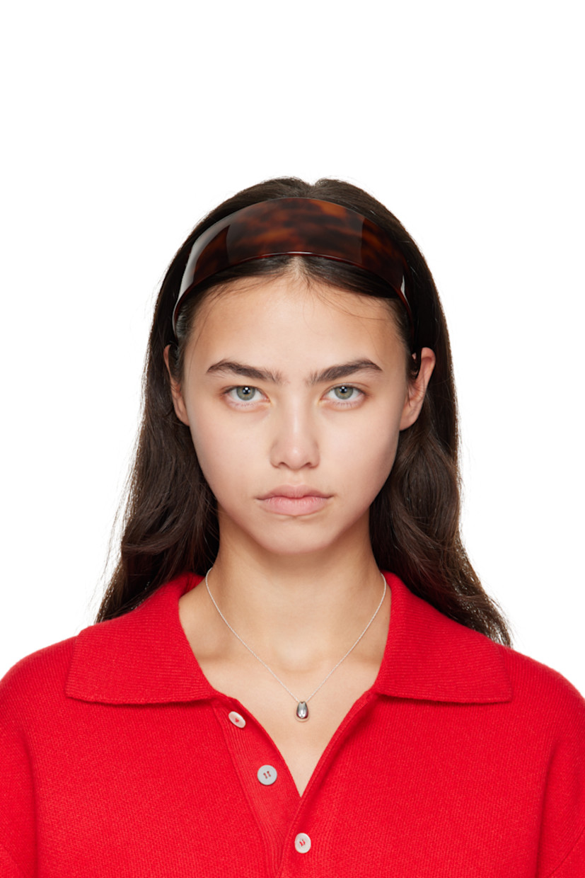 Tortoiseshell acetate headband.

· Combs and logo plaque at inner side
· W2"

Supplier color: Tortoise