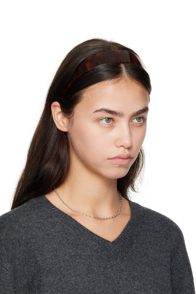 Tortoiseshell acetate headband.

· Combs and logo plaque at inner side
· W1.25"

Supplier color: Tortoise