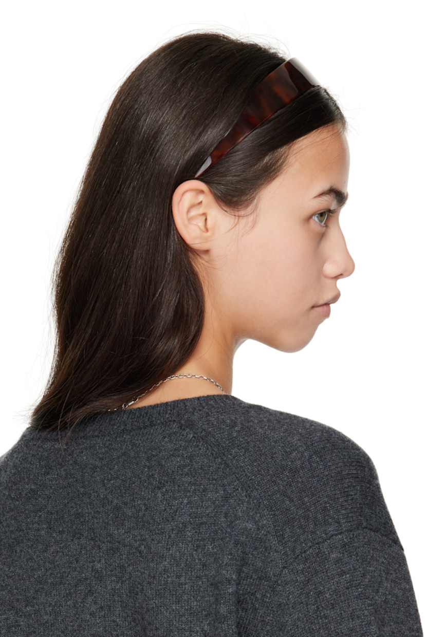 Tortoiseshell acetate headband.

· Combs and logo plaque at inner side
· W1.25"

Supplier color: Tortoise