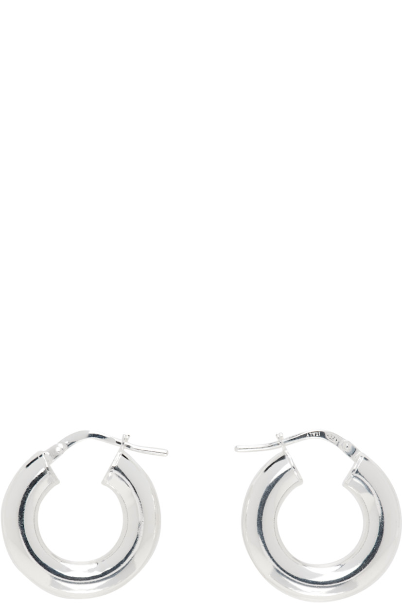 Pair of handcrafted hoop earrings in sterling silver. 

· Hinged-post fastening 
· D0.75"

Supplier color: Sterling silver