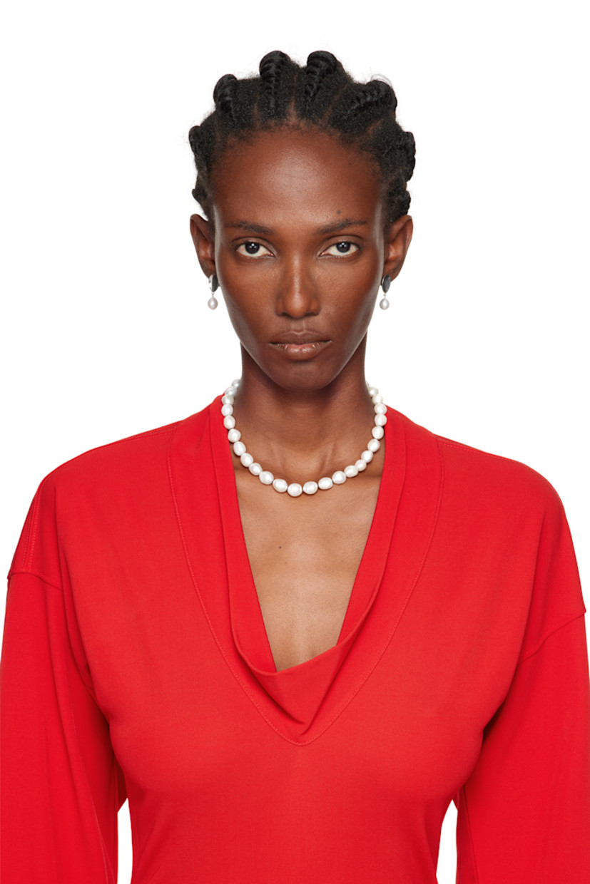 Pair of handcrafted drop earrings in sterling silver.

· Freshwater pearl at drop
· Post-stud fastening
· H1" x W0.5"

Supplier color: Sterling silver