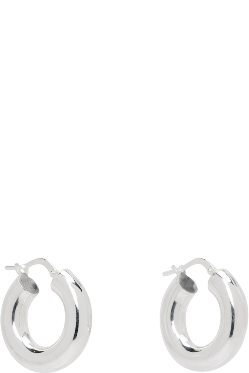Pair of handcrafted hoop earrings in sterling silver.

· Hinged-post fastening
· D0.75"

Supplier color: Sterling silver