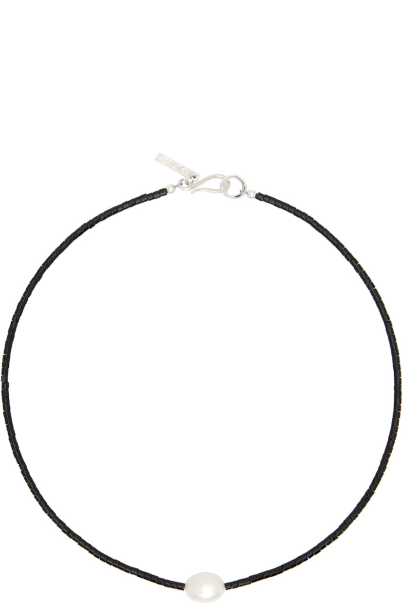 Handcrafted beaded black agate seed choker.

· Freshwater pearl at face
· Logo plaque at hook-eye fastening 
· Sterling silver hardware 
· L14.5"

Supplier color: Pearl