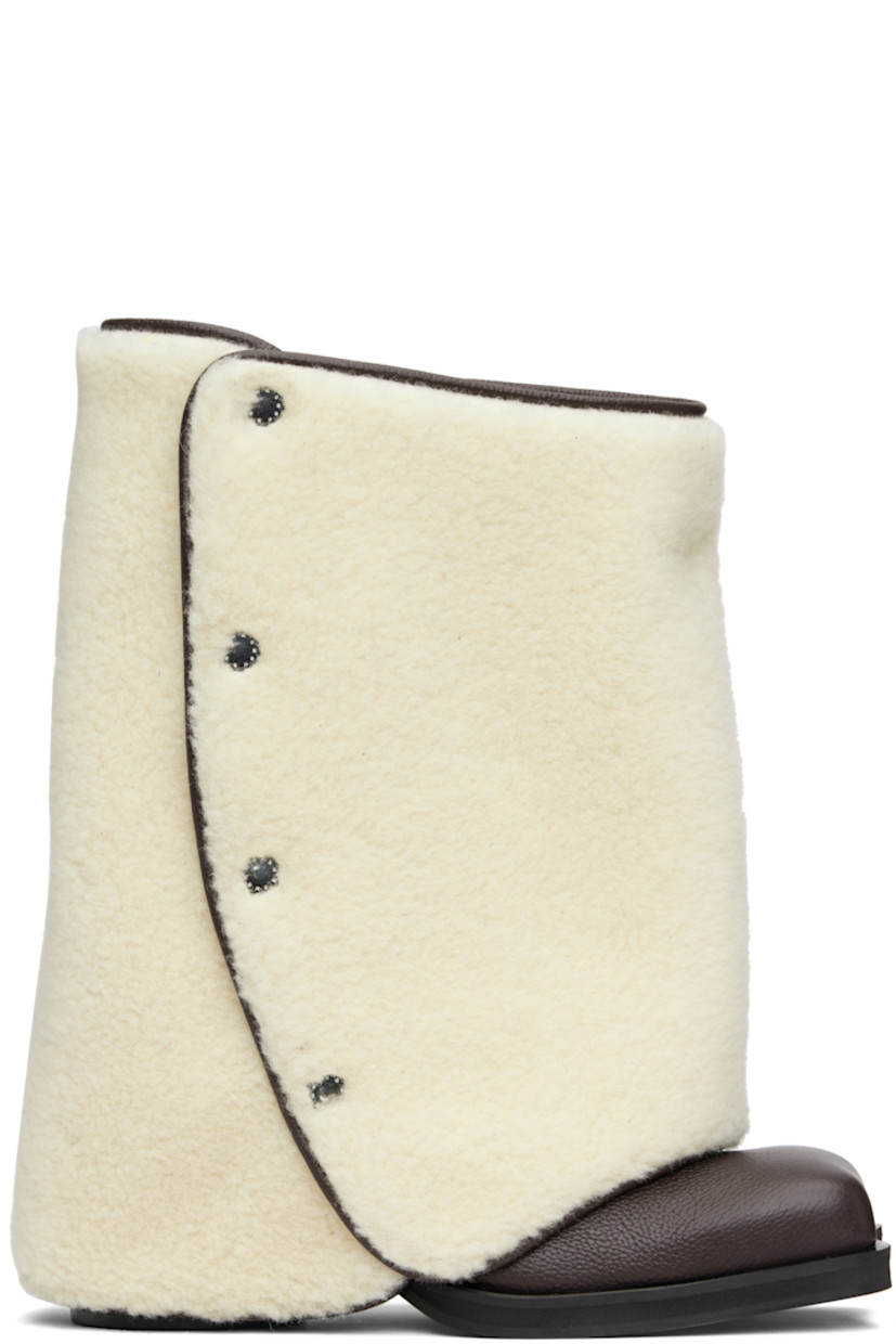Mid-calf grained leather boots.

· Detachable wool fleece overlay
· Square toe
· Elasticized gusset at sides
· Logo printed at outer side
· Buffed leather lining
· Stacked leather heel with rubber injection
· Leather sole
· Heel: H2.75"

Supplier color: Brown